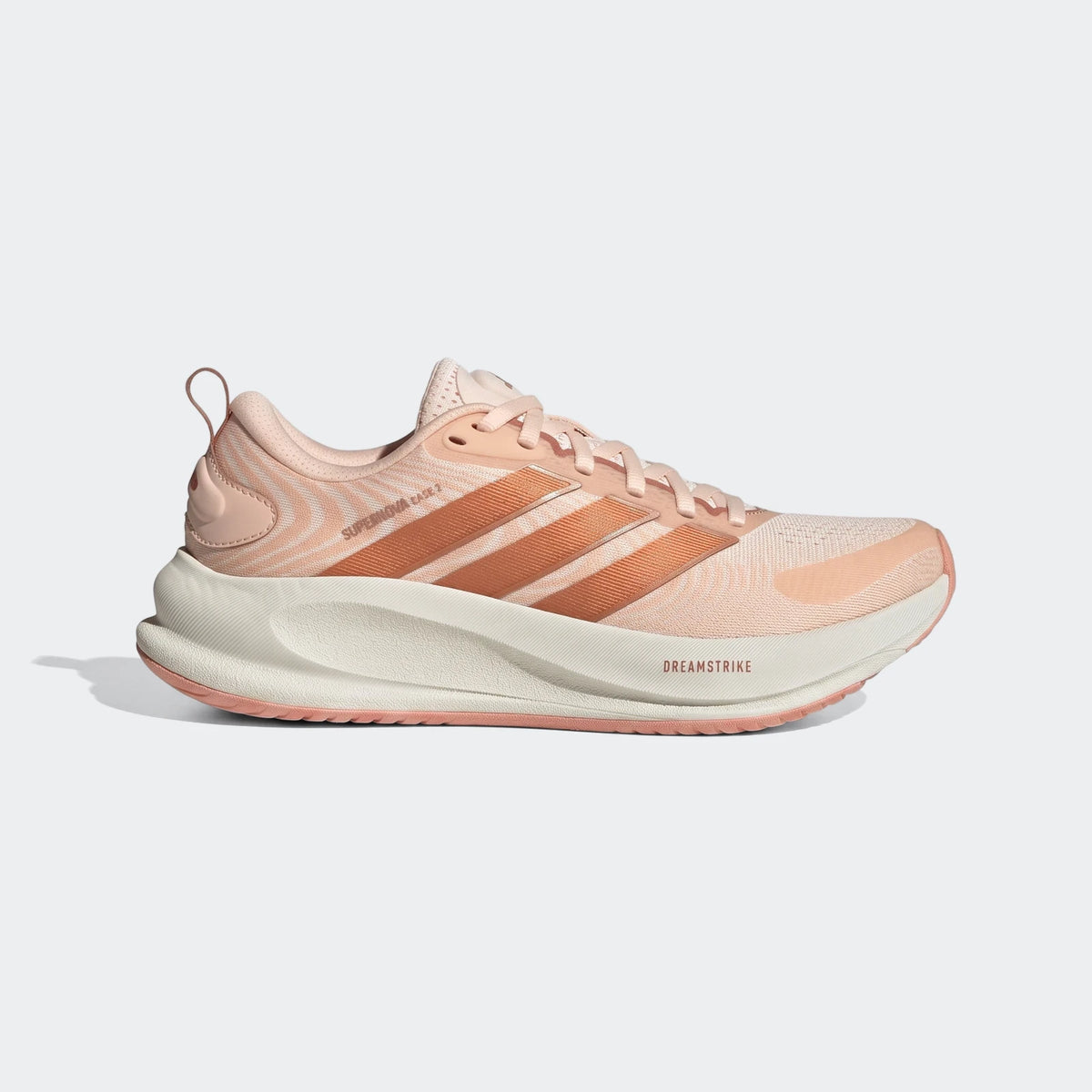 Adidas Supernova Ease 2 running shoes in peach with copper stripes and a cream sole, shown from a side view.