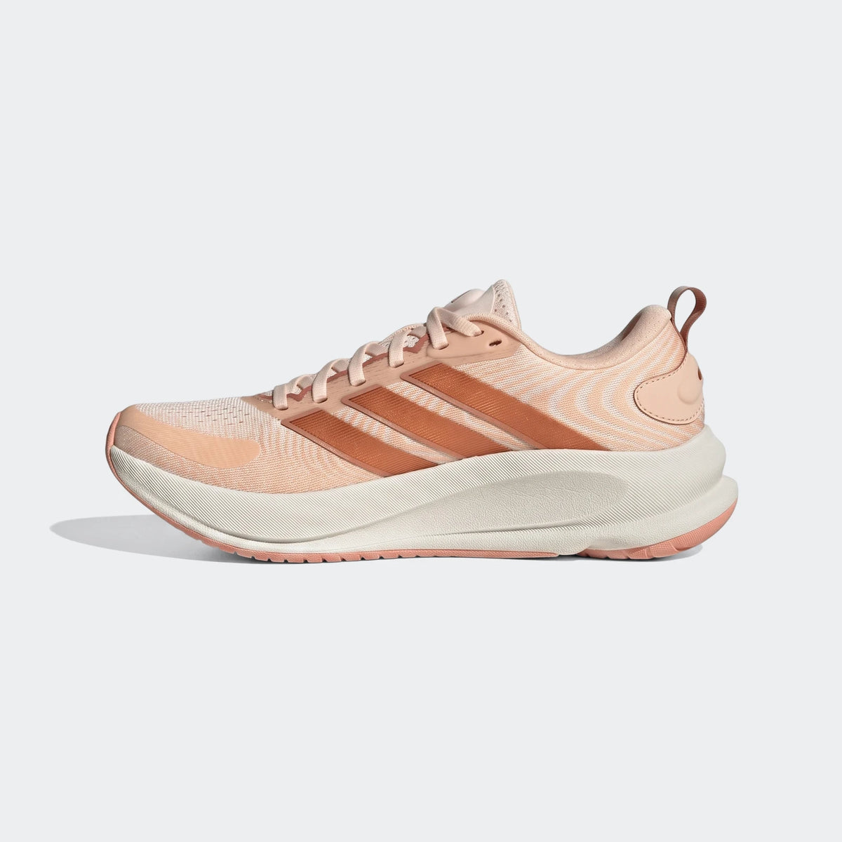 Adidas Supernova Ease 2 running shoes in peach and white, captured in a clear side profile view, showcasing the design.