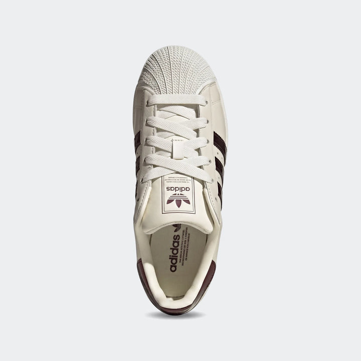 Top-down view of an off-white Adidas Superstar II shoe with dark brown three stripes and heel detail.