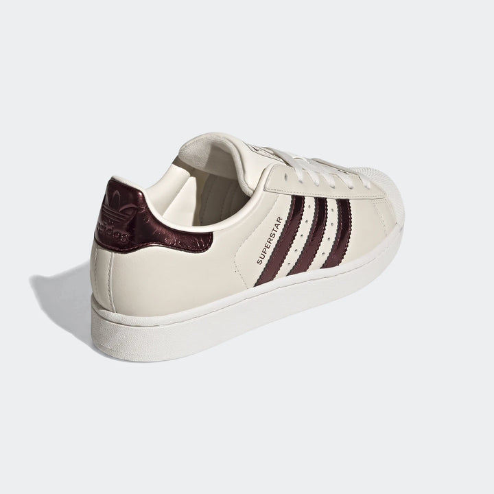 Adidas Superstar II Shoes in creamy off-white with burgundy stripes and heel tab, white laces, and classic shell toe, shown