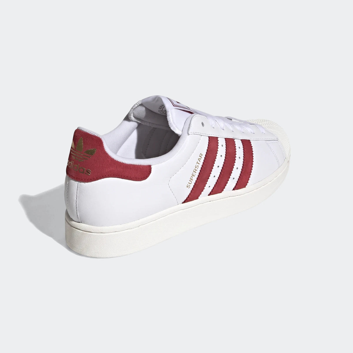 White and red leather Adidas Superstar II shoes, showcasing the iconic shell toe and three stripe design.