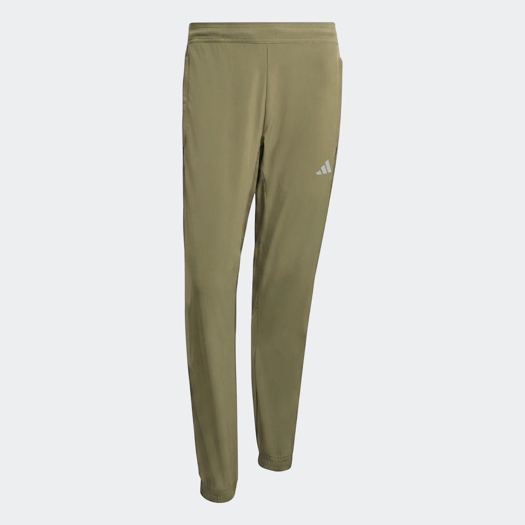 Olive green Adidas Technical Apparel Slim Pants, laid flat, featuring a reflective logo.