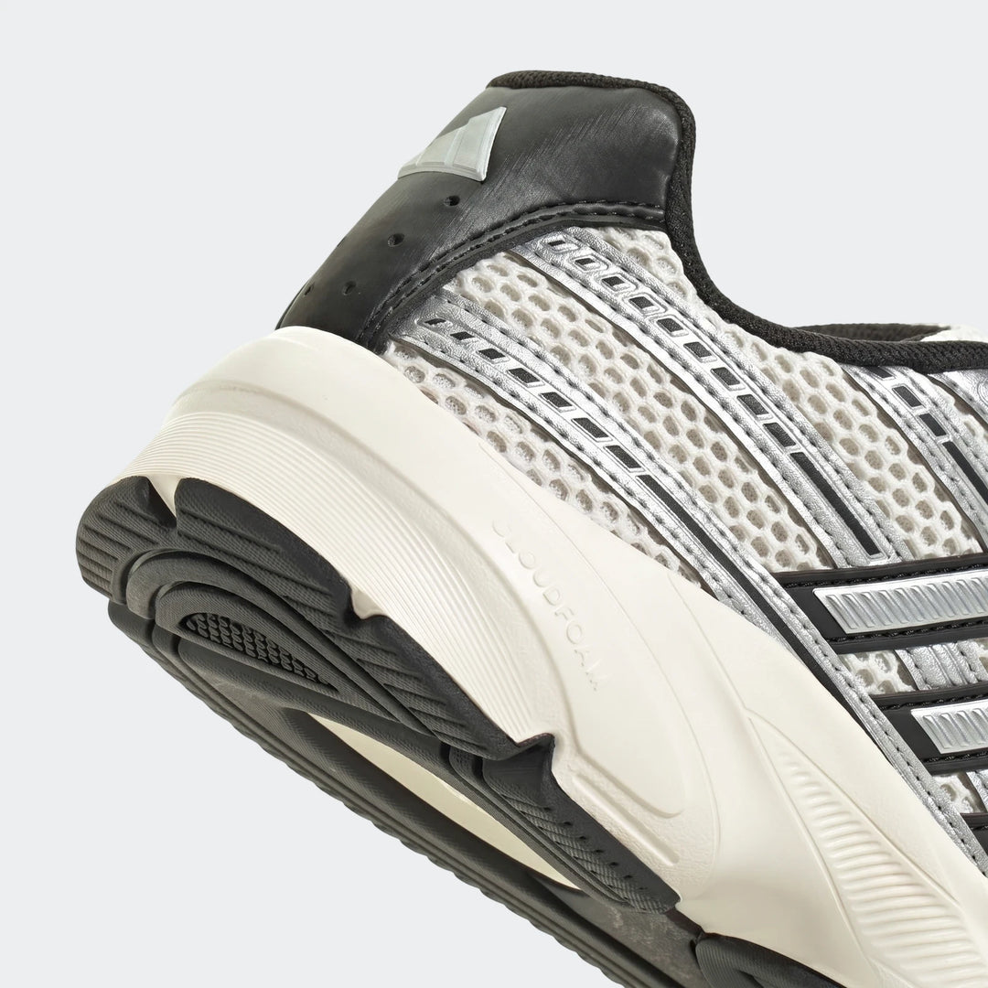 Close-up of Adidas Technochaos 2000 Shoes, showing the gray mesh upper, black heel with branding, and white Cloudfoam