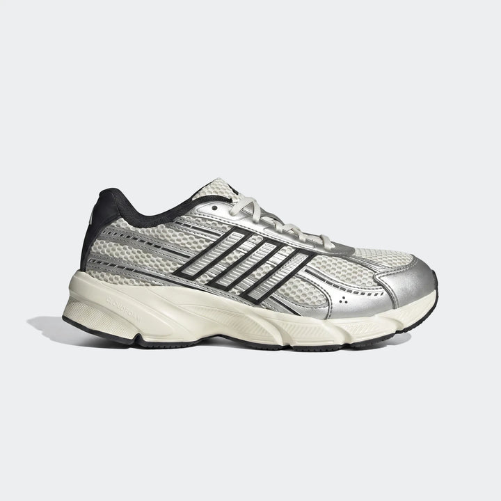 Adidas Technochaos 2000 running shoes featuring white mesh, metallic silver accents, and black stripes on a neutral