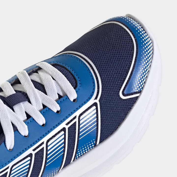 Close-up of a blue and white Adidas Tensaur Run 4.0 Junior running shoe, showcasing the mesh upper, synthetic overlays, and