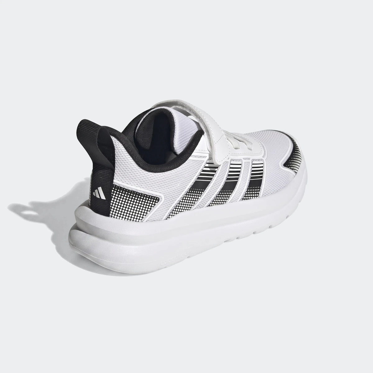 White and black Adidas Tensaur Run 4.0 children's shoes with hook-and-loop strap closure, shown from a rear-quarter view.