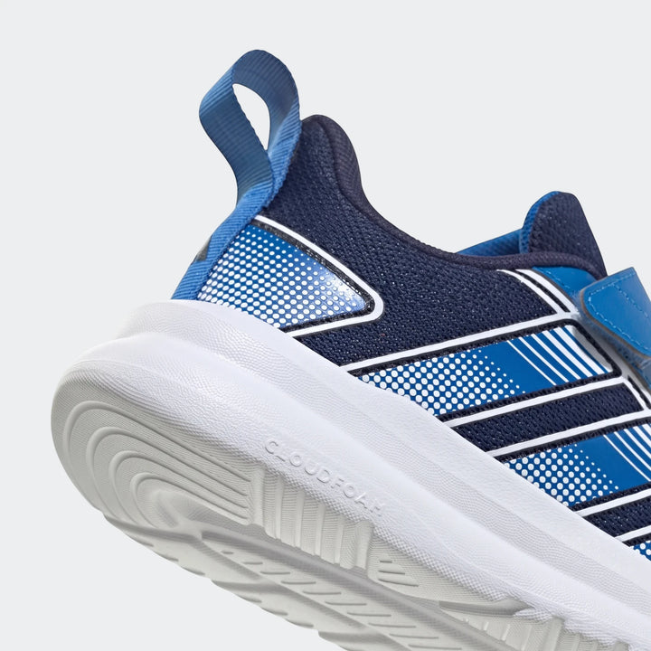 Close-up side view of a navy and royal blue Adidas Tensaur Run 4.0 children's sneaker with white stripes and a white