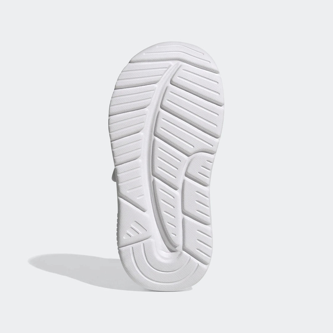 White Adidas Tensaur Run 4.0 Infants' shoe, sole view, showcasing the intricate tread pattern and durable rubber.
