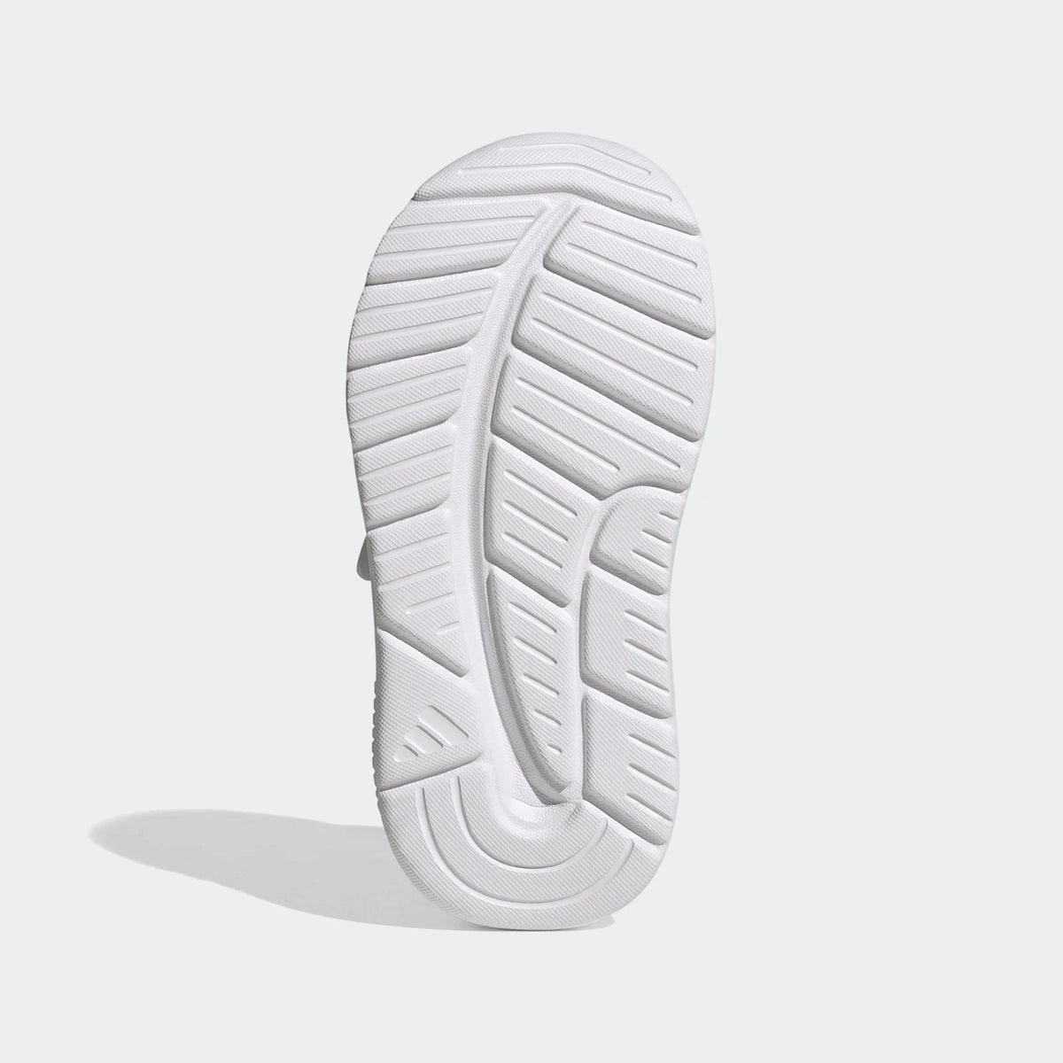 White Adidas Tensaur Run 4.0 Infants' shoe, sole view, showcasing the intricate tread pattern and durable rubber.