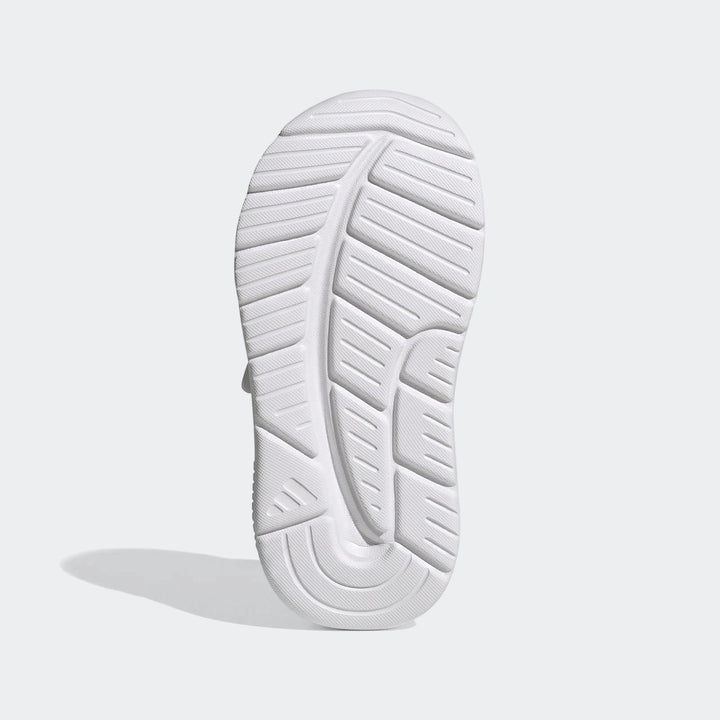 White Adidas Tensaur Run 4.0 Infants' shoe, sole view, showcasing the intricate tread pattern and durable rubber.