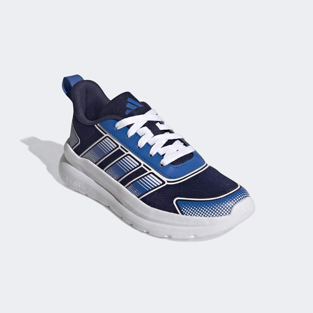 Adidas Tensaur Run 4.0 Junior shoes in navy blue, royal blue, and white, viewed from a three-quarter angle.