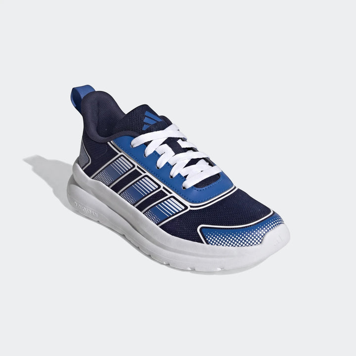 Adidas Tensaur Run 4.0 Junior shoes in navy blue, royal blue, and white, viewed from a three-quarter angle.