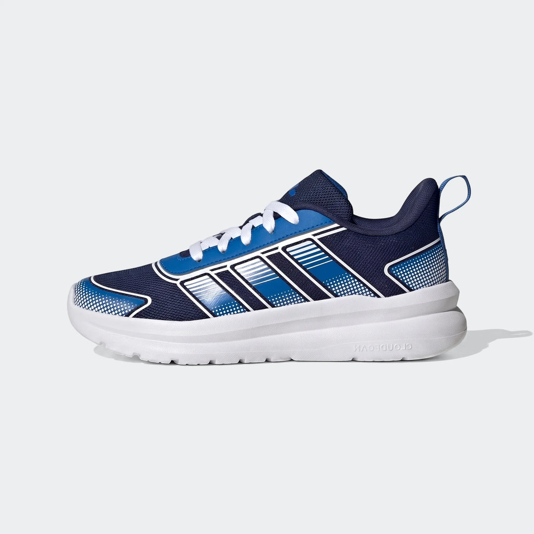 Side view of a blue and white Adidas Tensaur Run 4.0 Junior shoe, featuring white laces and a thick white sole.