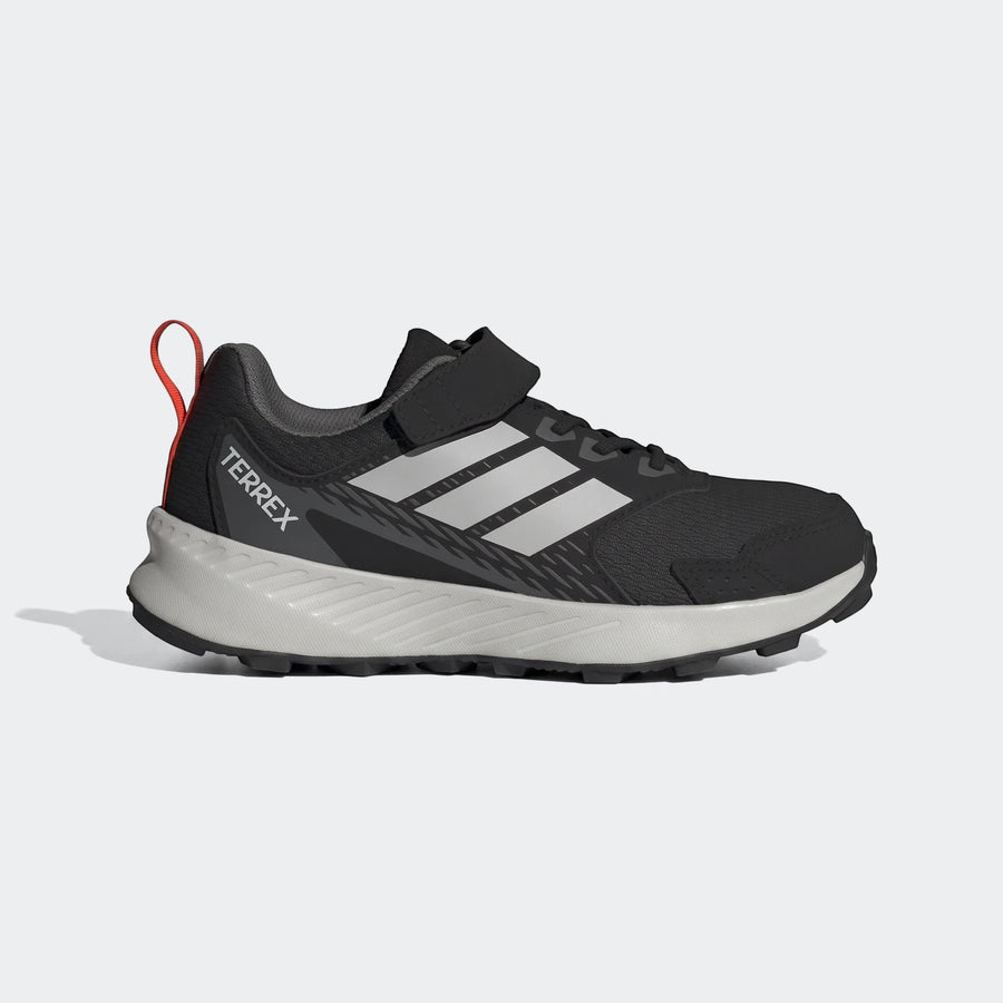 Adidas Terrex Tracefinder Cf C kids' shoes in black and white with a red pull tab and Velcro closure, shown from the side.