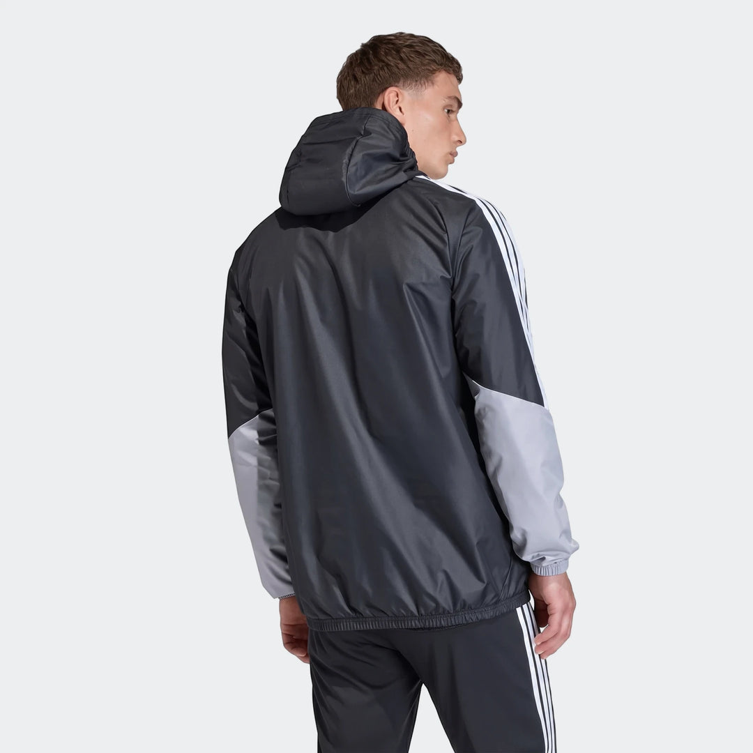 Male model wearing a black and gray Adidas Tiro 26 Competition All-Weather Jacket with white stripes, viewed from the back.