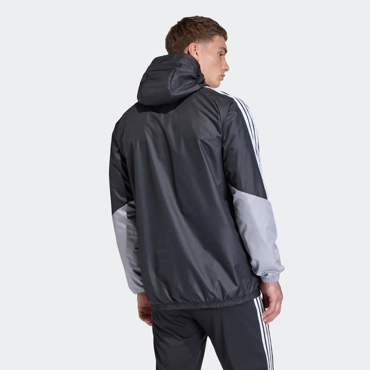 Male model wearing a black and gray Adidas Tiro 26 Competition All-Weather Jacket with white stripes, viewed from the back.