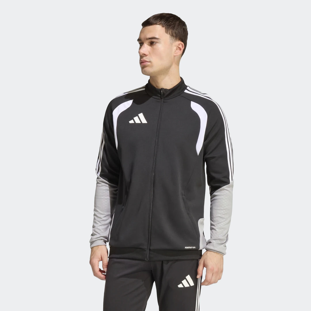 Male model wearing a black, white, and grey Adidas Tiro 26 Competition Training Jacket with a zipped front.