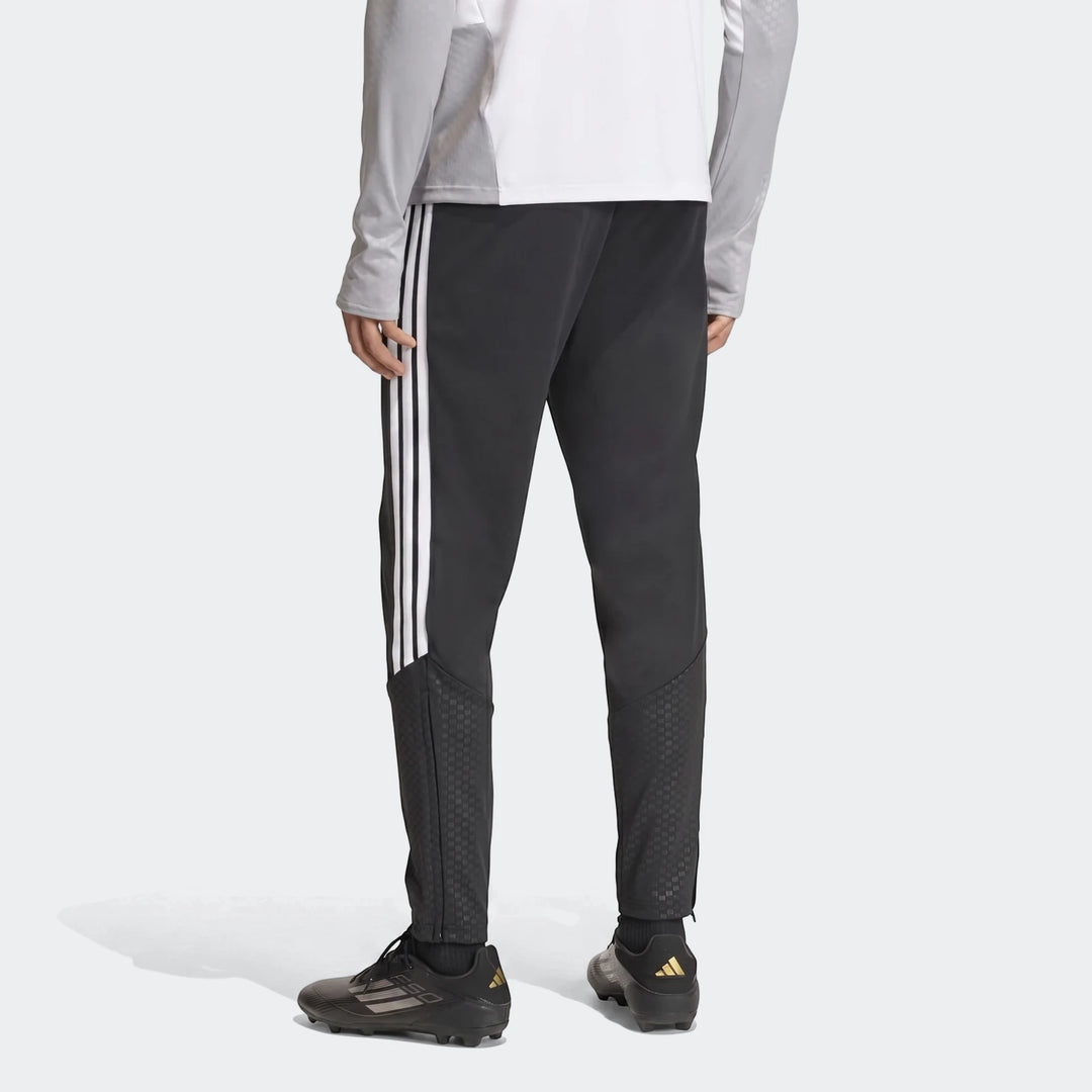 Black Adidas Tiro 26 Competition Training Pants on a model, featuring white stripes and textured lower leg panels, rear view.