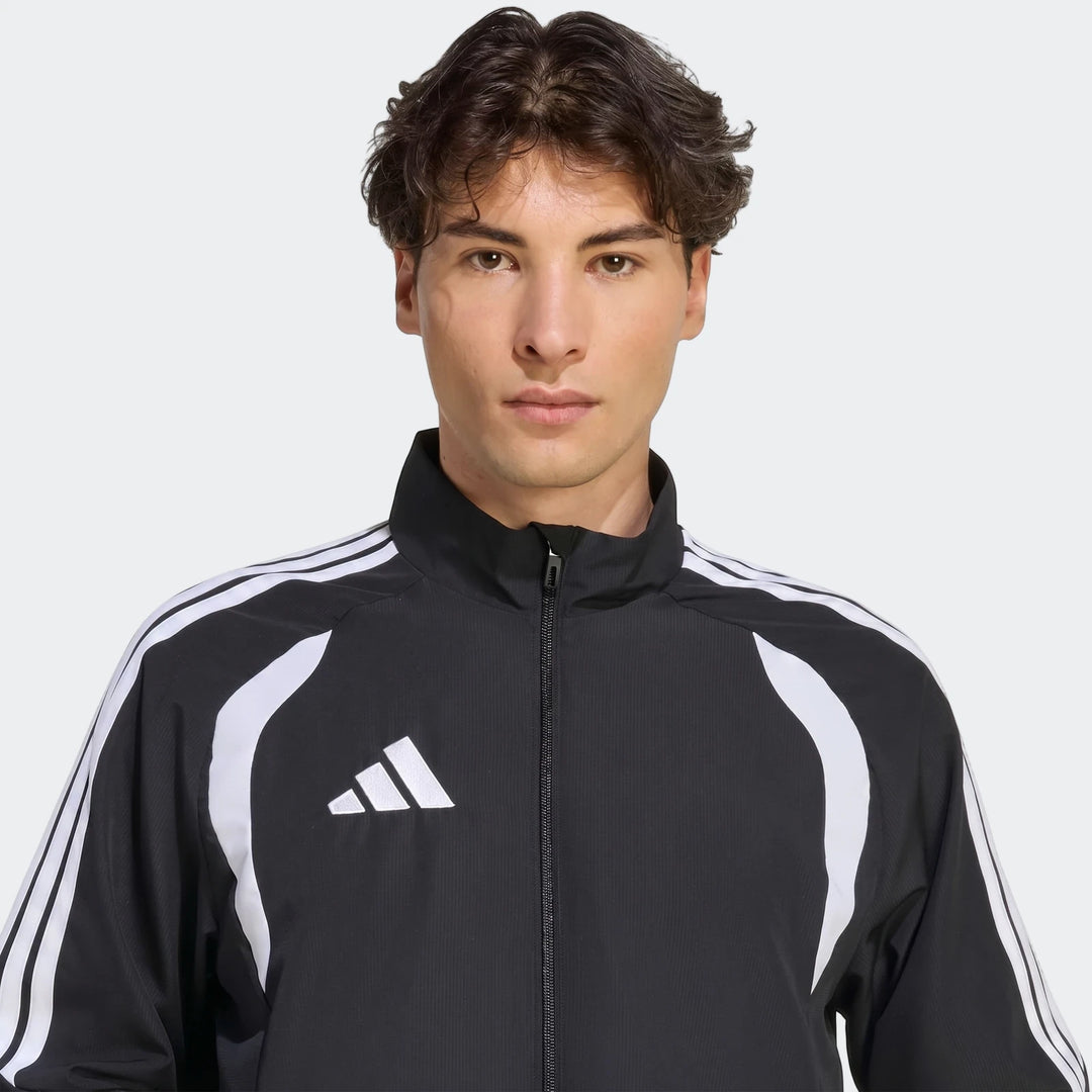 Front view of a male model wearing a black Adidas Tiro 26 League Presentation Jacket featuring white three-stripe details