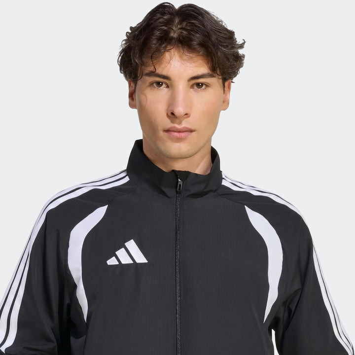 Front view of a male model wearing a black Adidas Tiro 26 League Presentation Jacket featuring white three-stripe details