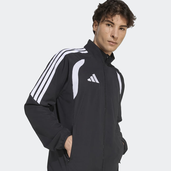 Black Adidas Tiro 26 League Presentation Jacket with white three-stripes and logo, worn by a male model, photographed from