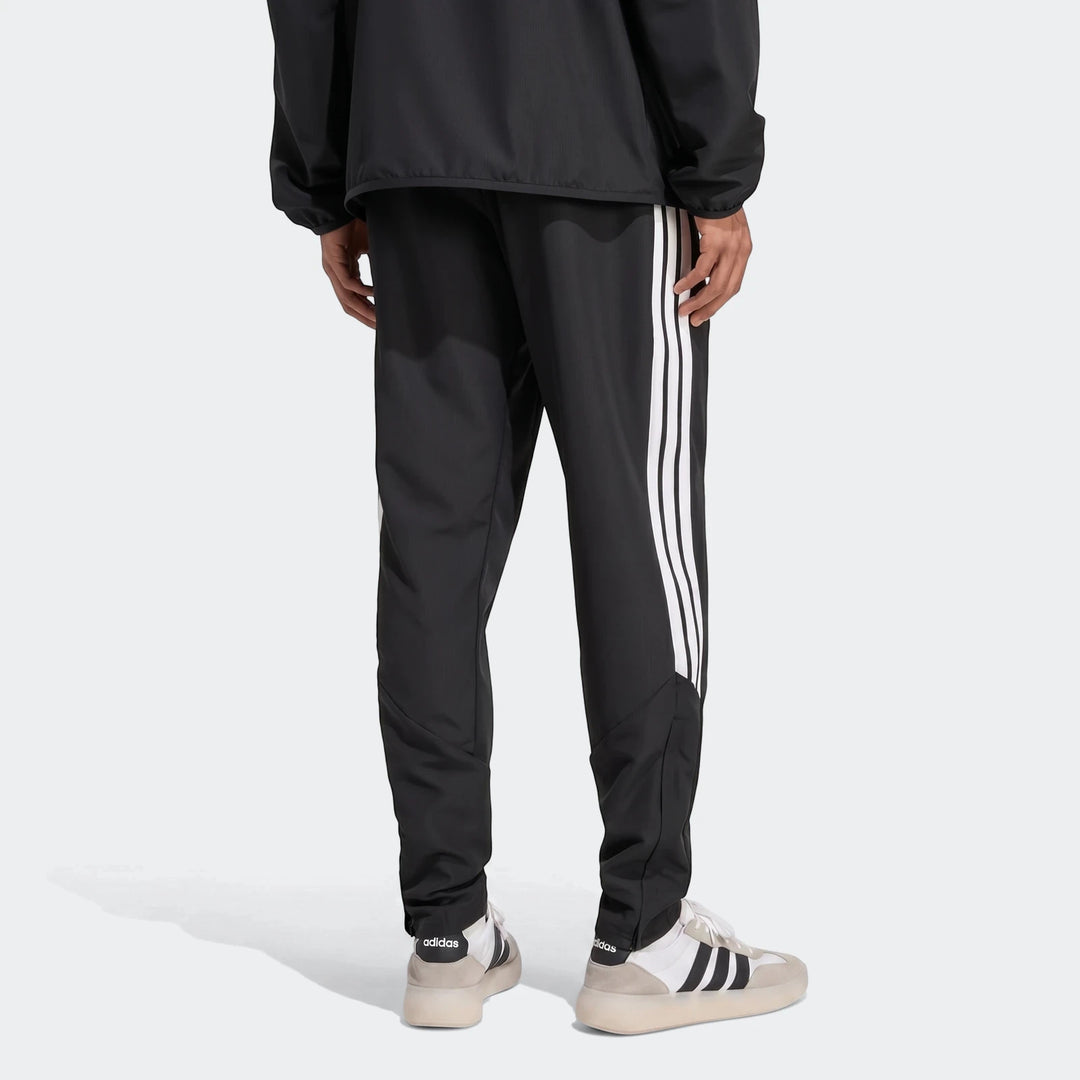 Black Adidas Tiro 26 League Presentation Pants with white 3-stripes, worn by a person seen from the back, showcasing the