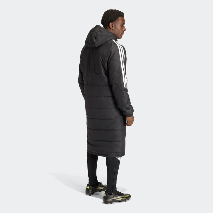 Men's black Adidas Tiro 26 long padded coat with white stripes, worn by a model in full body back view.