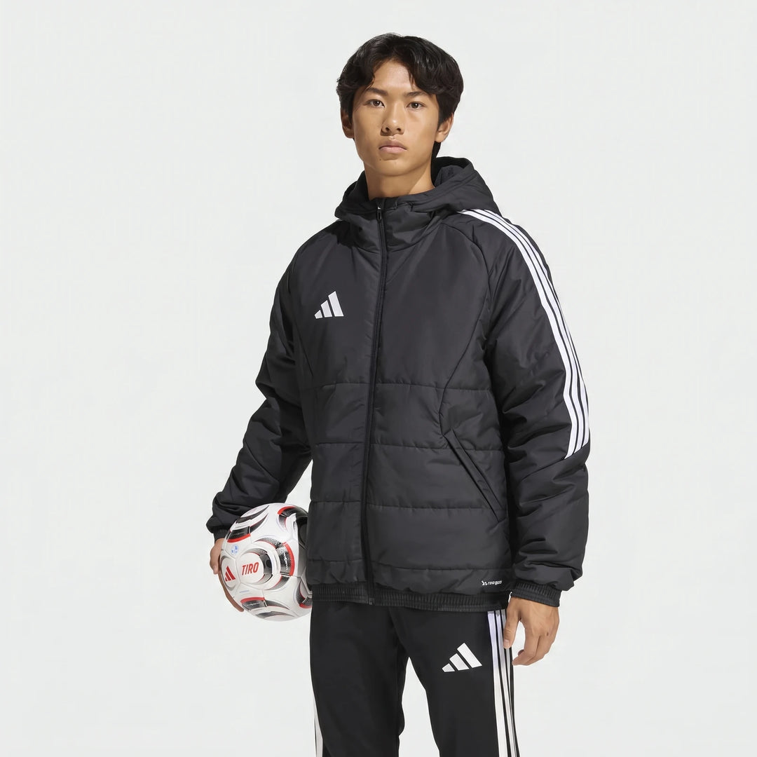 Male model wearing a black Adidas Tiro 26 Windbreaker Jacket and track pants, holding a white soccer ball.