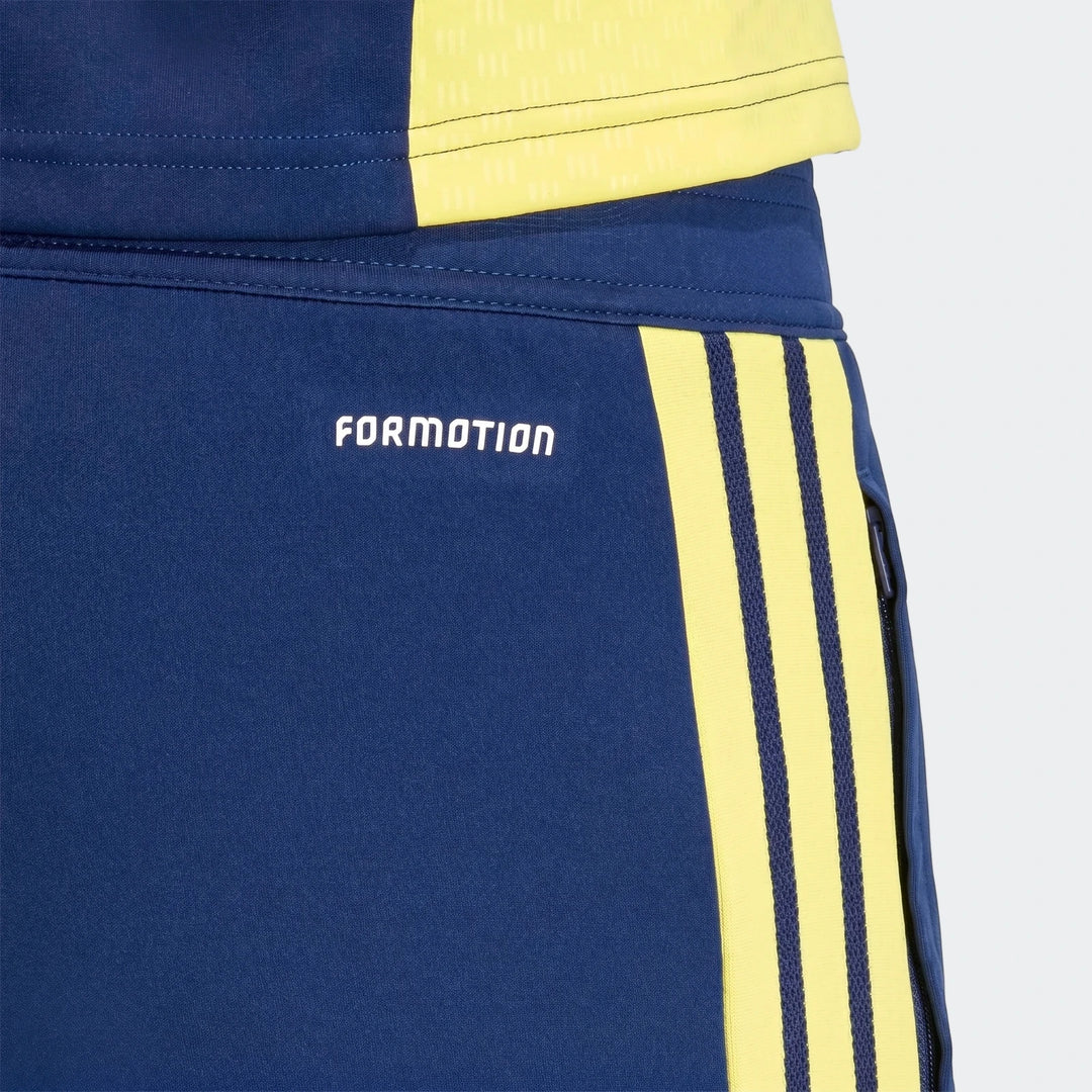 Close-up of navy blue Adidas Tiro26 training pants featuring three vibrant yellow stripes and a white Formotion logo on the