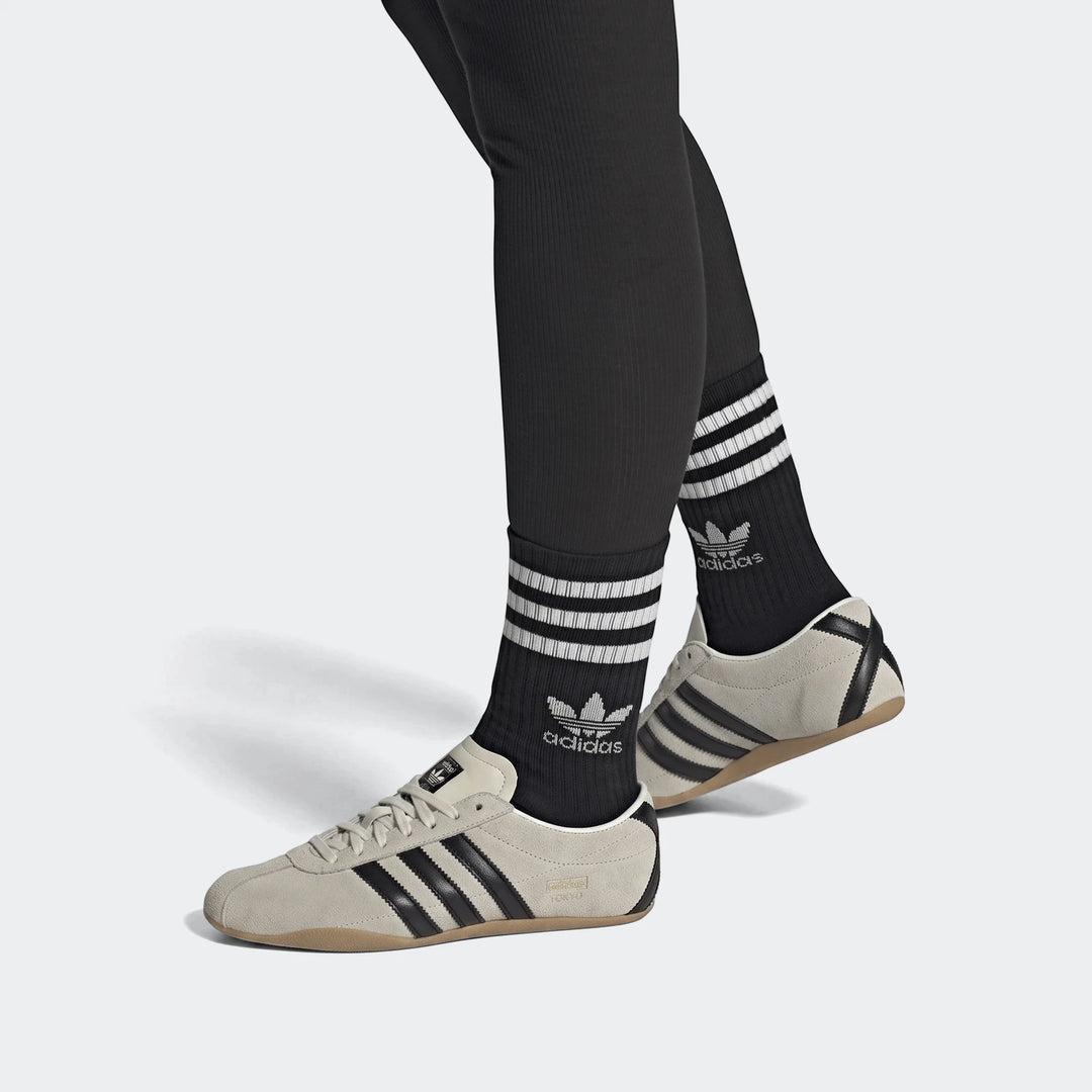 Adidas Tokyo Shoes, beige suede with black stripes and gum sole, worn with black Adidas Trefoil socks and leggings, shown on