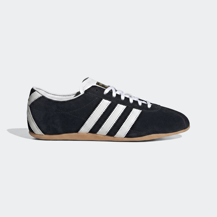 Adidas Tokyo Shoes in black suede with white leather stripes and a light brown gum sole, shown in a side profile.