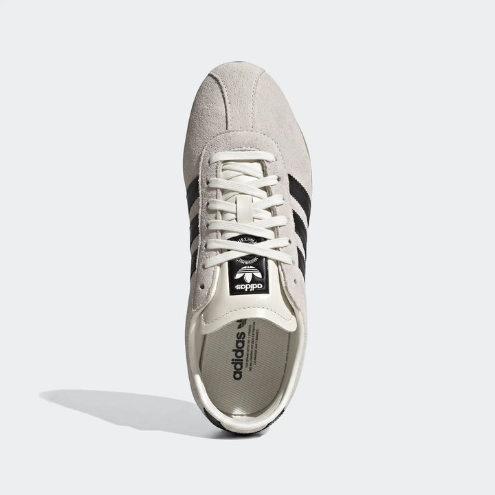 Adidas Tokyo Shoes in light grey suede with black stripes and white laces, viewed from the top down.