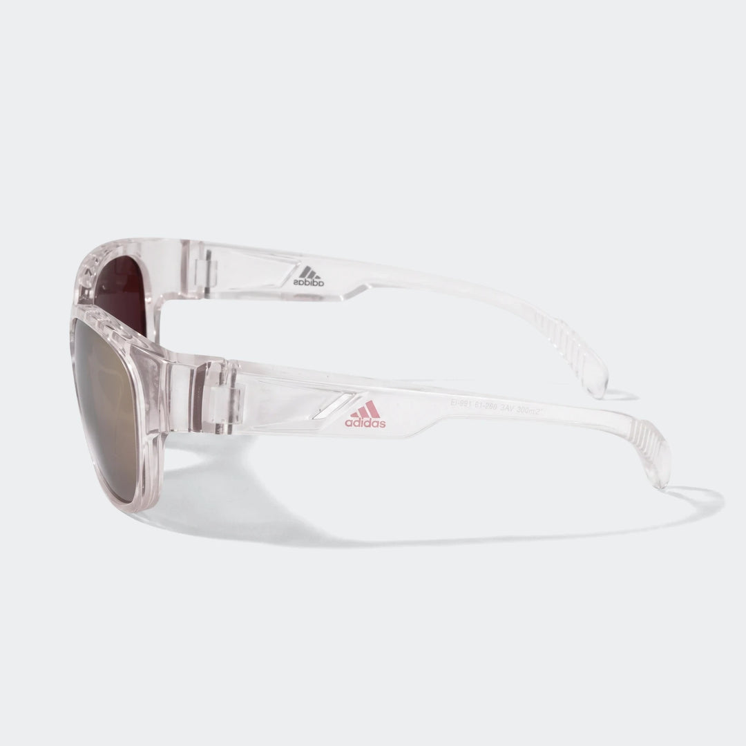 Adidas Transparent Sunglasses featuring a clear frame and brown lenses, showcasing the iconic logo on the side in a stylish