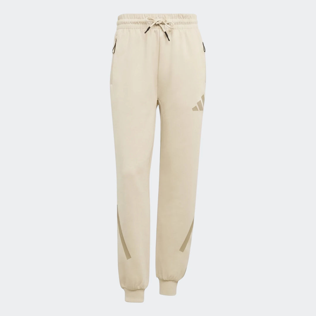 Beige Adidas W Z.N.E. track pants, styled with a drawstring waist and ribbed cuffs, presented in a flat lay front view.