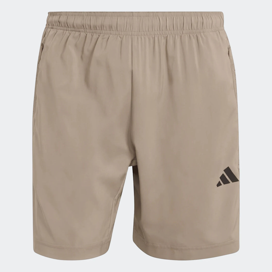 Beige Adidas Workout Essentials Base Woven Shorts for men, featuring an elastic waistband, side pockets, and black logo.