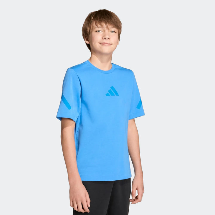 A young boy models the bright blue Adidas Youth Z.N.E. T-Shirt with diagonal sleeve stripes, captured in a frontal studio