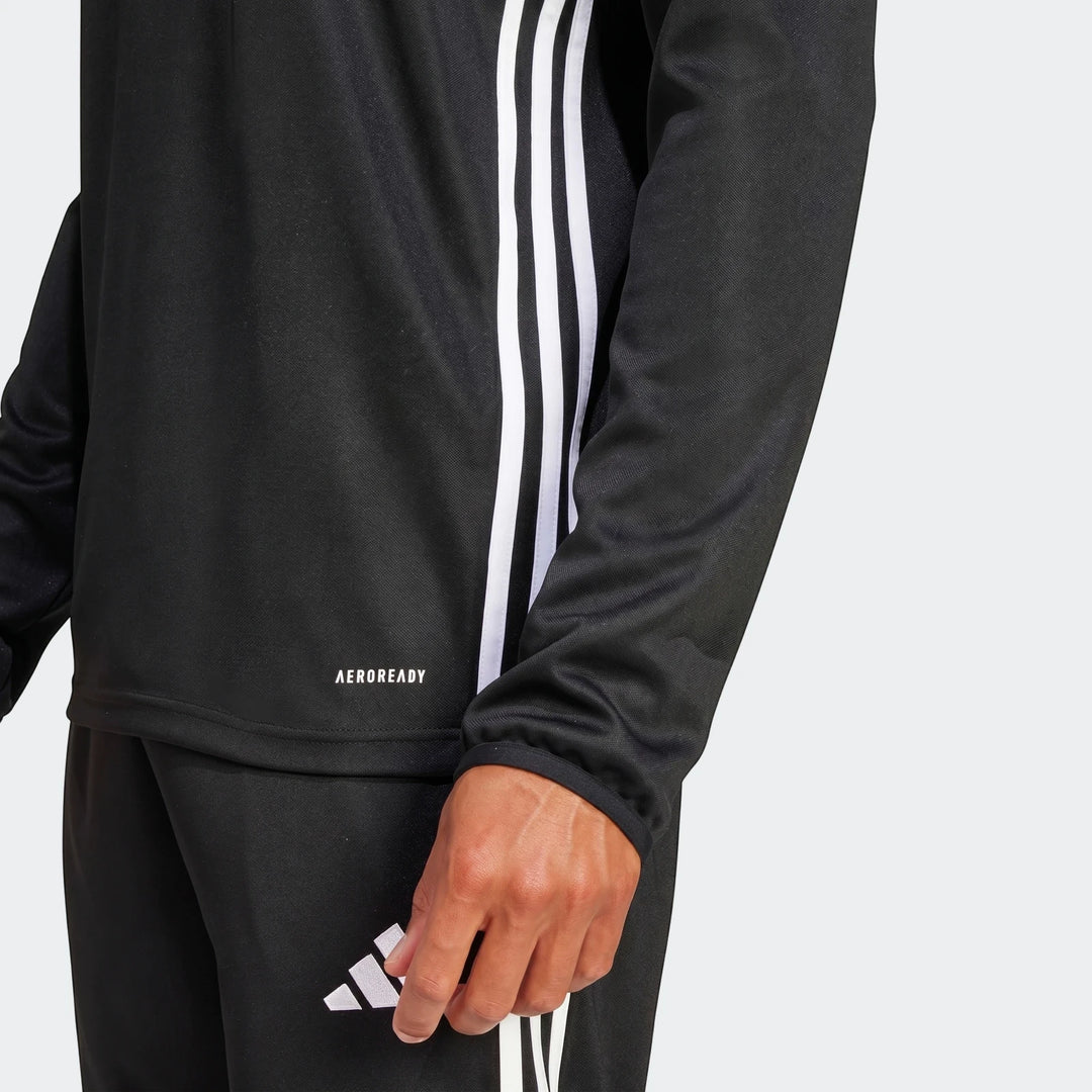Black Adidas Z.N.E. Track Top with white 3-stripes and AEROREADY logo, worn by a person, showing the sleeve and hand.