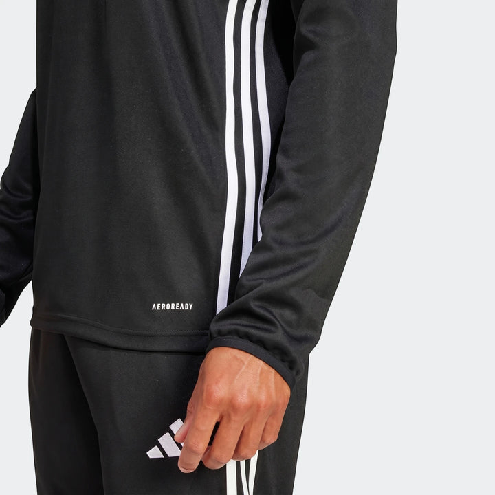 Black Adidas Z.N.E. Track Top with white 3-stripes and AEROREADY logo, worn by a person, showing the sleeve and hand.