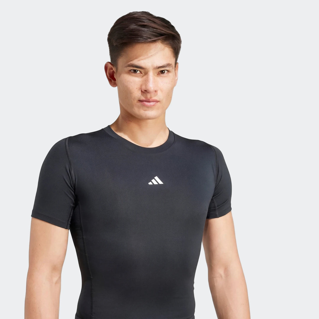 Male model wearing a black short-sleeved Adidas Z.N.E. Track Top, designed for athletic performance.