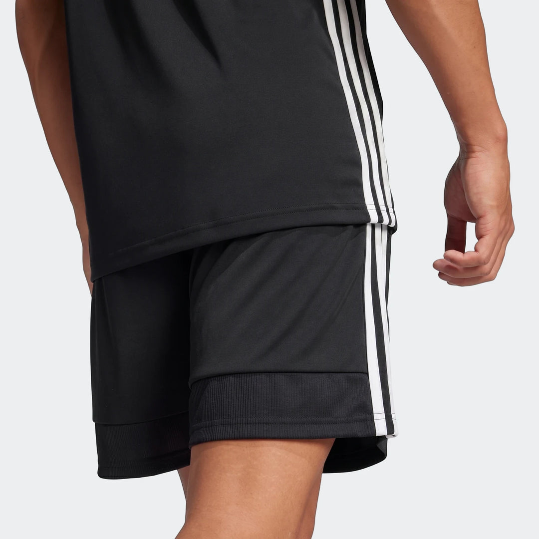 Person wearing a black Adidas Z.N.E. Track Top and matching black shorts with white three-stripe detailing, viewed from the
