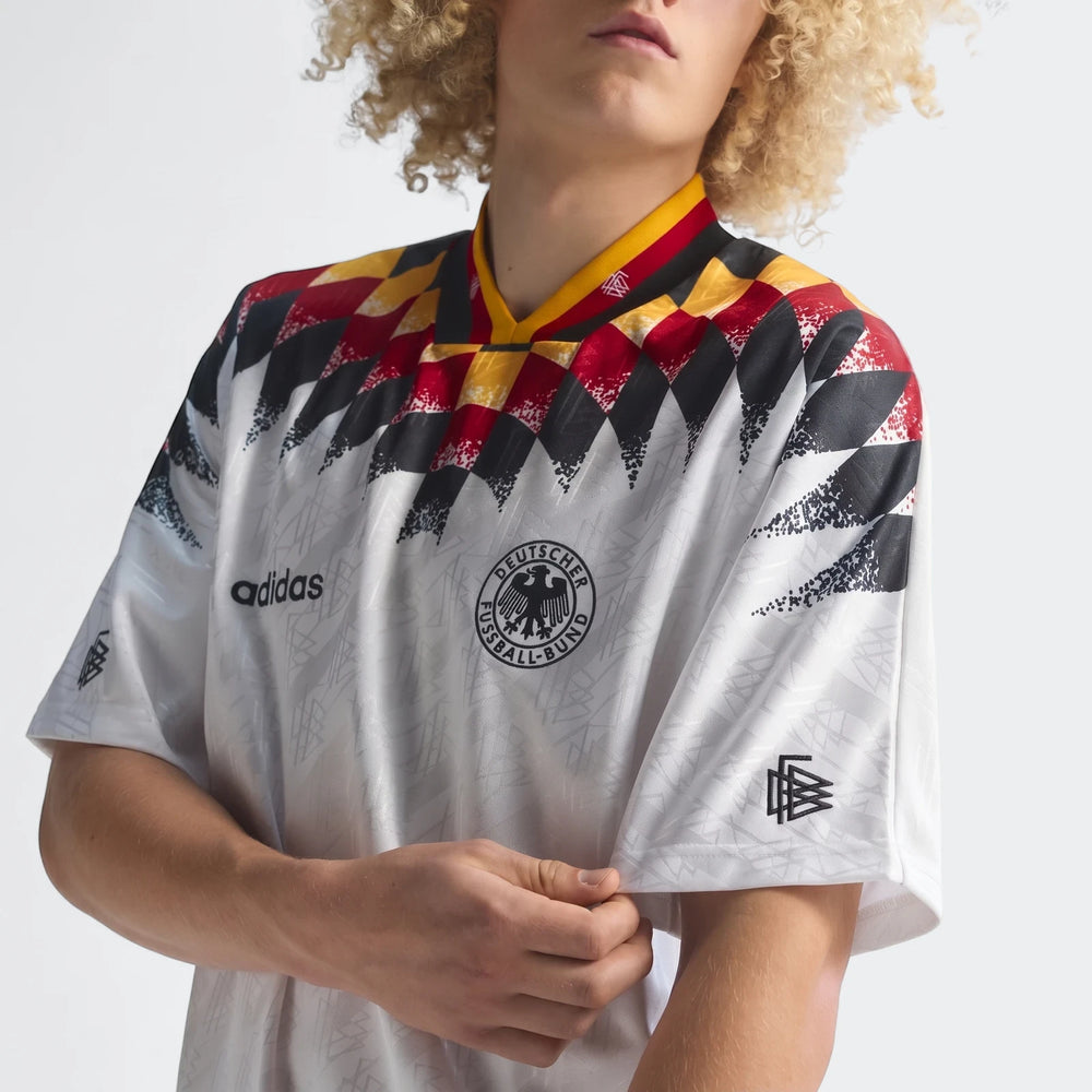 Adidas Z.N.E. Track Top, white with black, red, and yellow diamond pattern on chest and sleeves, worn by a model.