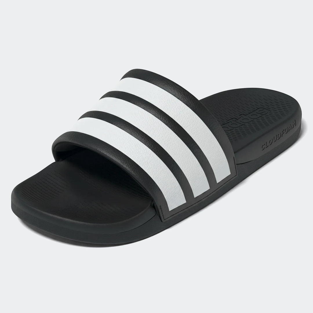 Black and white Adidas Adilette Comfort 2.0 Slides, angled view, showing textured strap with three white stripes.