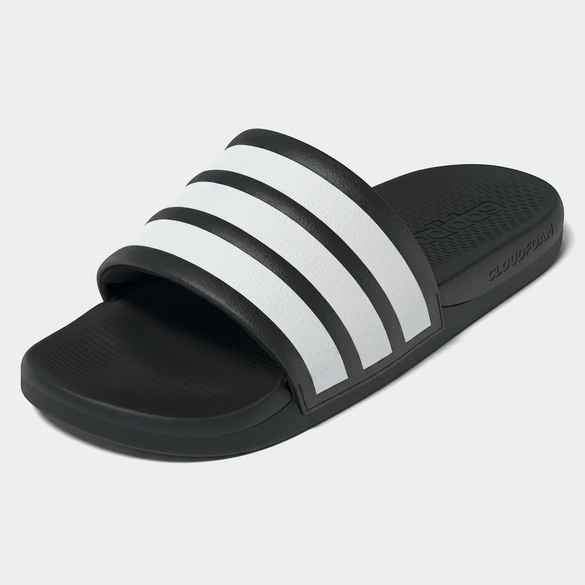 Black and white Adidas Adilette Comfort 2.0 Slides, angled view, showing textured strap with three white stripes.