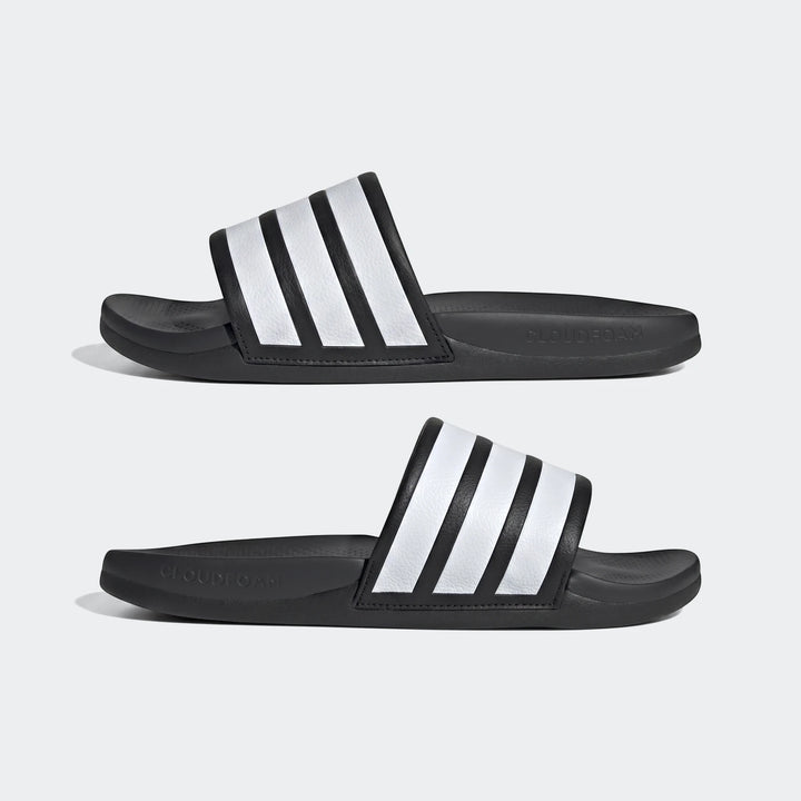 Two black Adilette Comfort 2.0 slides featuring iconic white stripes, presented side-by-side at an angle.