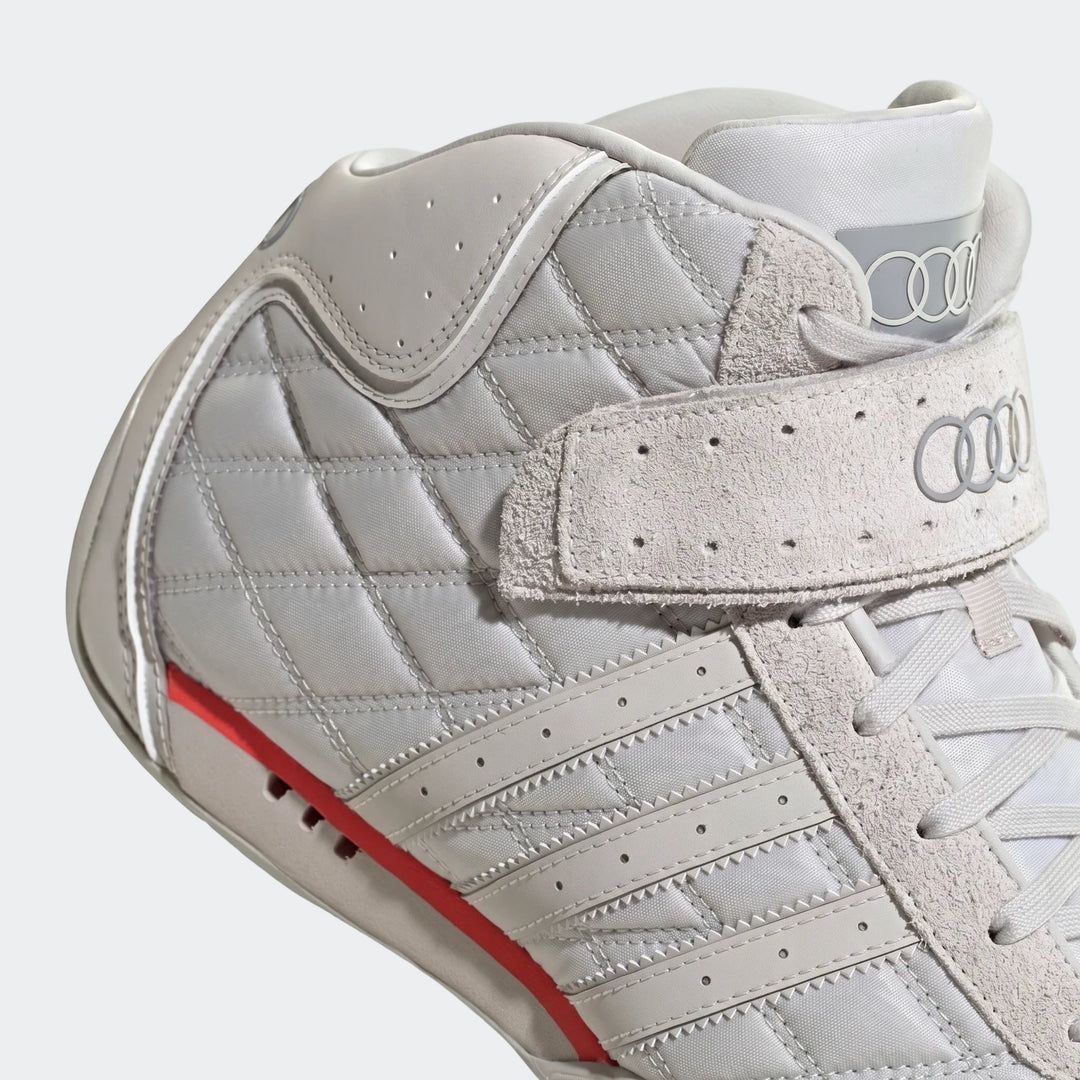 Close-up of a grey Adiracer Hi Audi Revolut F1 Team shoe, featuring quilted panels, suede details, and Audi rings logo.