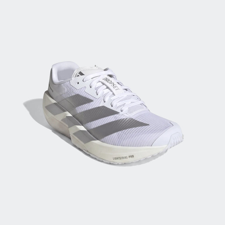 Adizero Dropset Pro training shoes in white with silver stripes, designed for performance, captured at a slight angle.