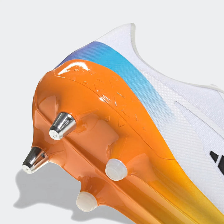 Close-up of a white, blue, and orange Adizero Rs15 Ultimate Sg Rugby Boot, showing the textured heel and studs.