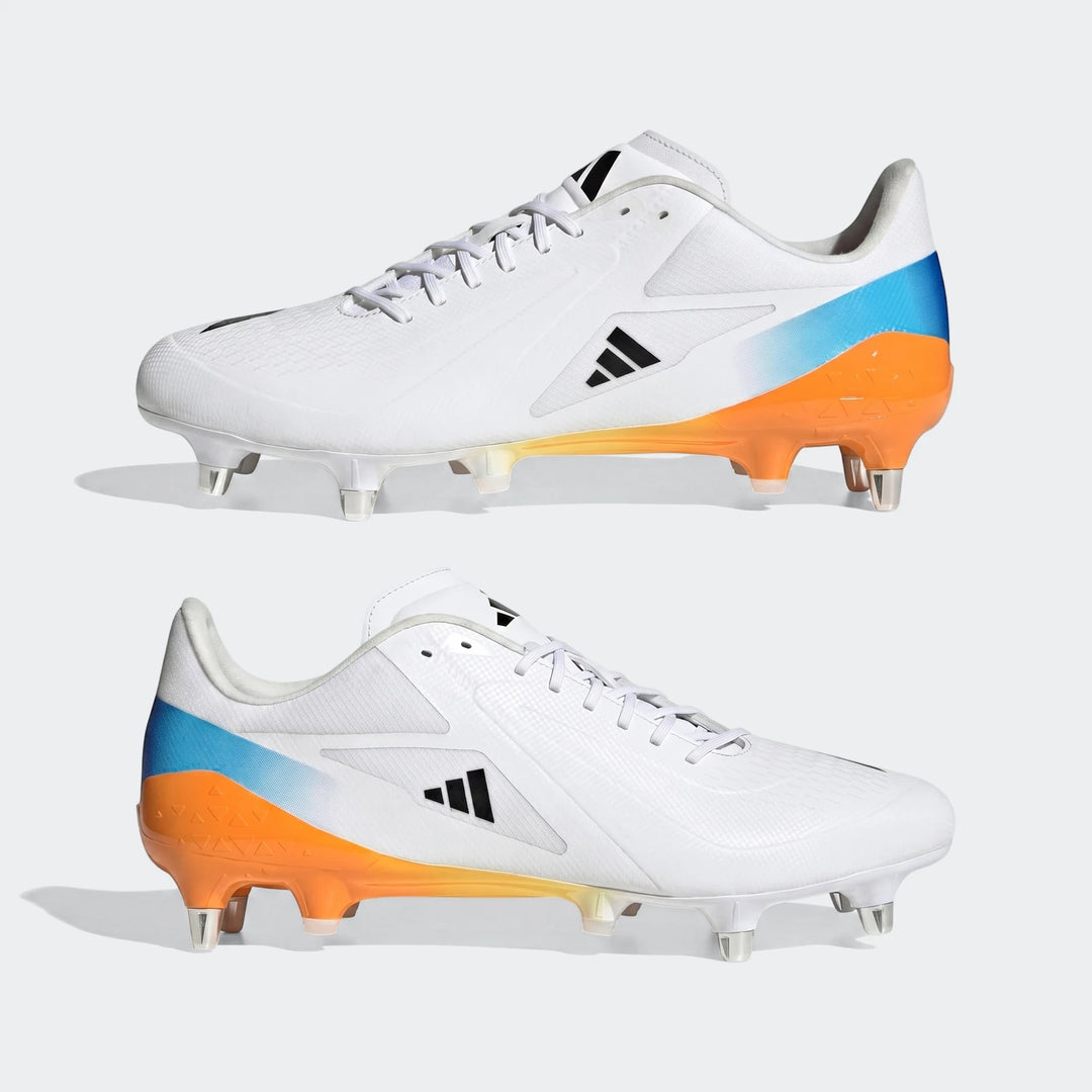 A pair of white Adizero Rs15 Ultimate SG Rugby Boots with black Adidas stripes, blue and orange gradient heels, and cleats.
