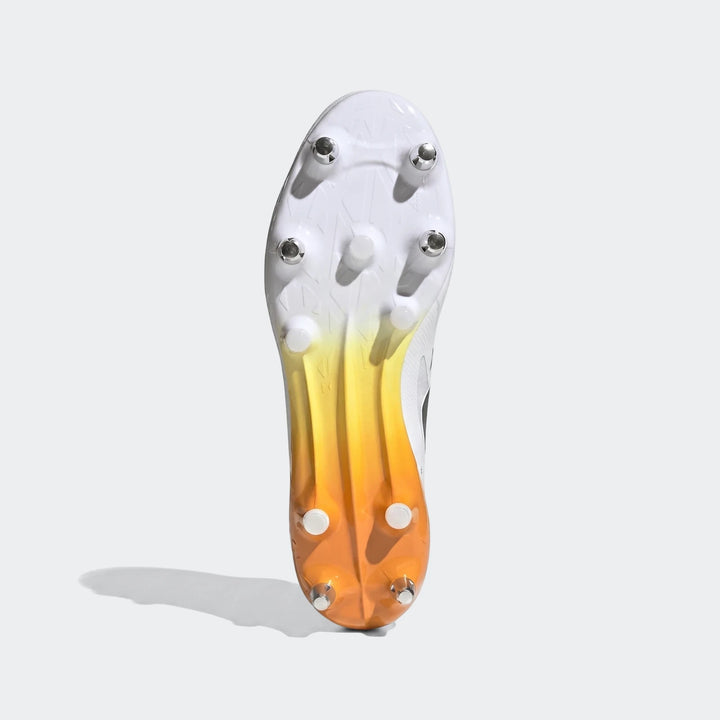 Adizero Rs15 Ultimate Sg Rugby Boots in white and yellow-orange, showing the studded soleplate from a bottom view.