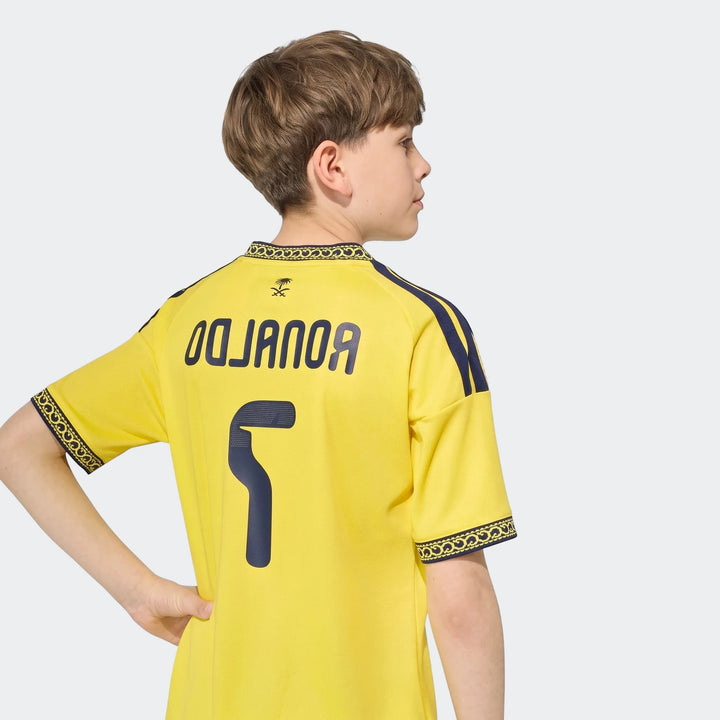 Al Nassr FC 26/27 Home Jersey for kids, yellow with blue accents, worn by a child model from the back, featuring number 5.